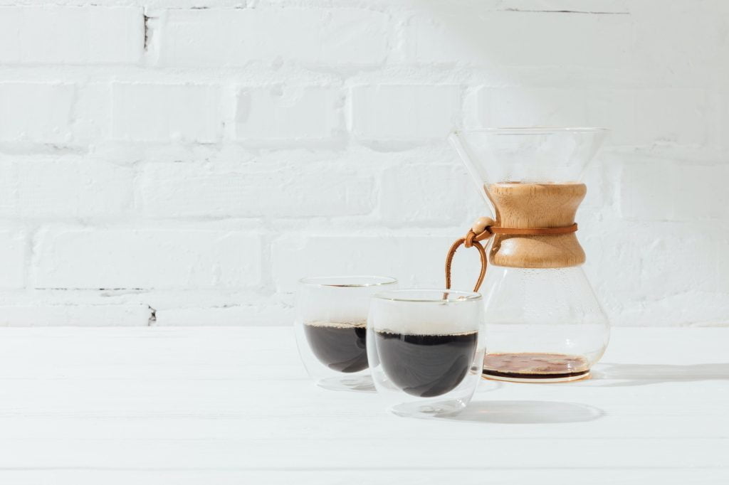 Two glass mugs with alternative coffee and chemex